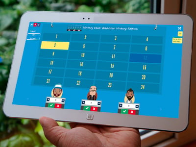 An iPad held by a user playing a Jeopardy game in Memory Mode with 3 other players.