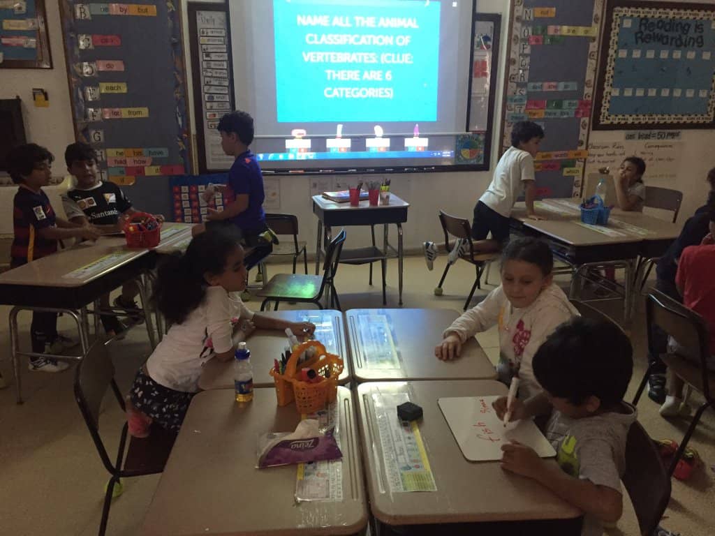 Kids playing a Jeopardy-style game in their classroom on Factile.